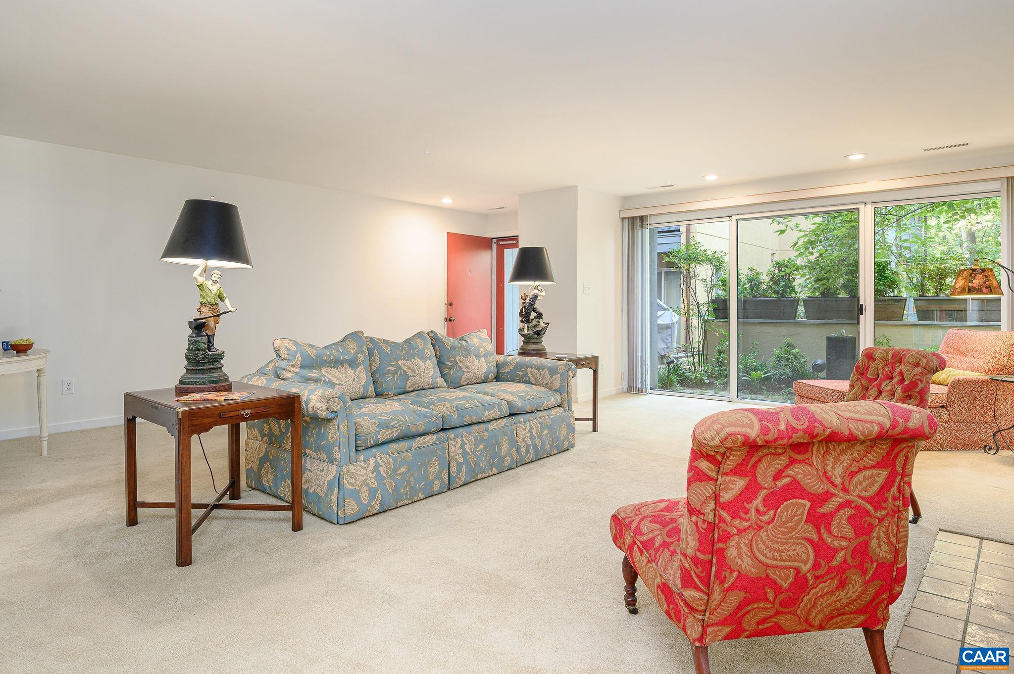 207 2nd Street Northwest, Unit D Charlottesville, VA 22902 - Photo 4 of 18 a living room with furniture and a large window