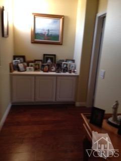 1889 Ribera Drive Oxnard, CA 93030 - Photo 8 of 22 a room with wooden floor and paintings on the wall