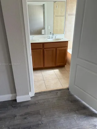 a bathroom with a granite countertop sink a toilet and bathtub