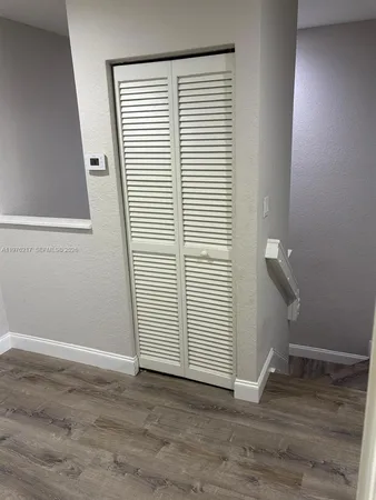 a view of a room with wooden floor