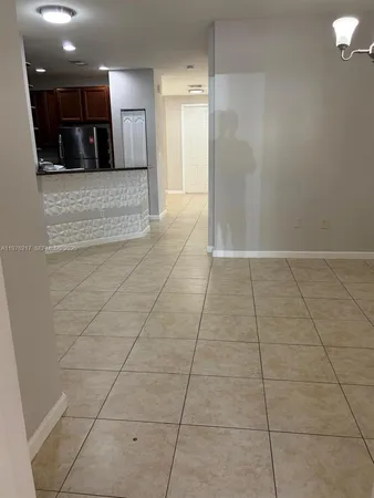 a kitchen with granite countertop a stove a microwave a sink and cabinets