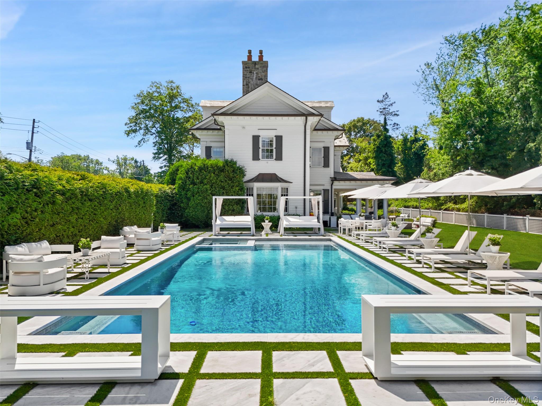 27 Murray Hill Road Scarsdale, NY 10583 - Photo 2 of 29 a aerial view of a house with swimming pool and porch