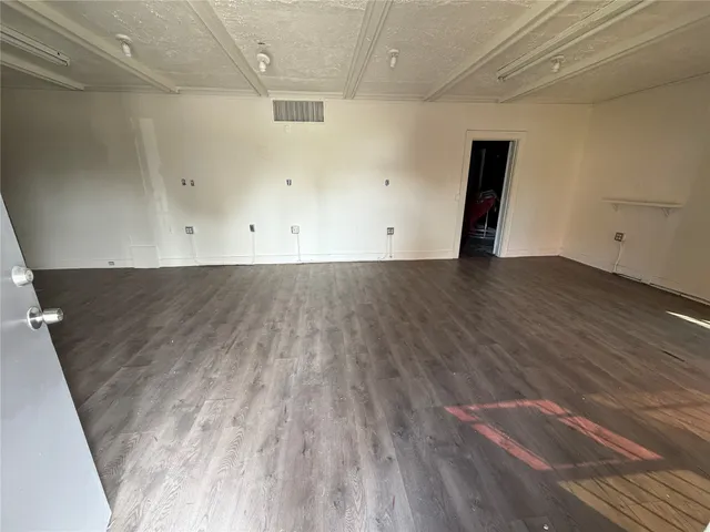 an empty room with wooden floor