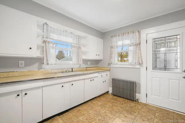 a spacious bathroom with a granite countertop sink and a window