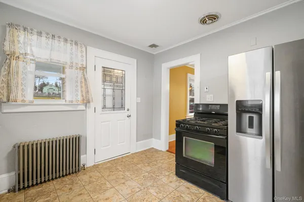a kitchen with granite countertop a stove and a refrigerator