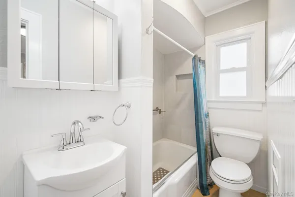 a white toilet sitting next to a bathroom sink