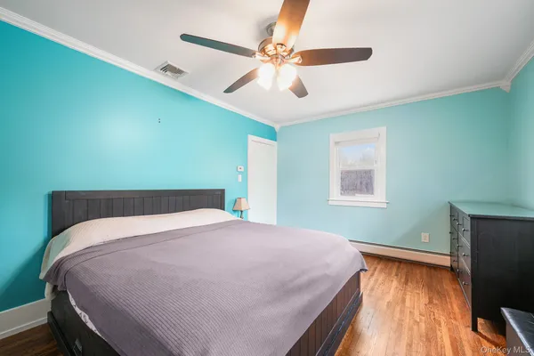 a bed sitting in a bedroom next to a window