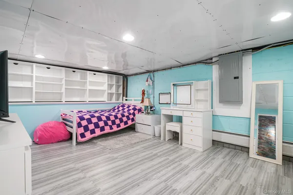 a bedroom with furniture and wooden floor