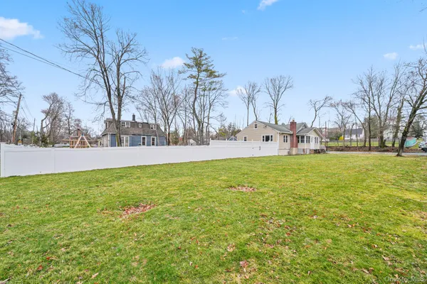a view of a backyard with large trees