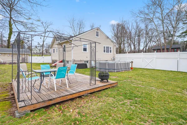 a backyard of a house with table and chairs