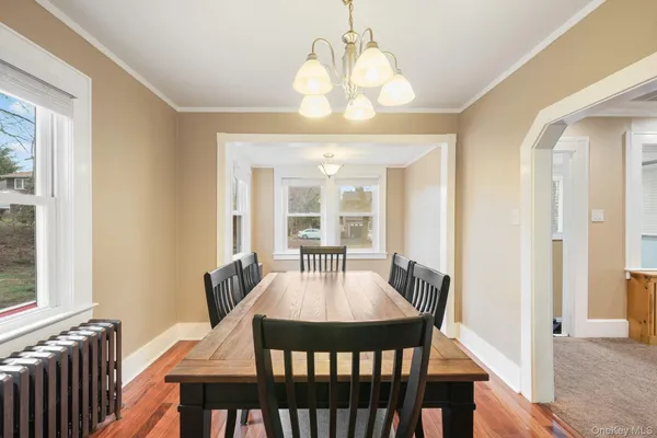 a view of a dining room with furniture window and wooden floor