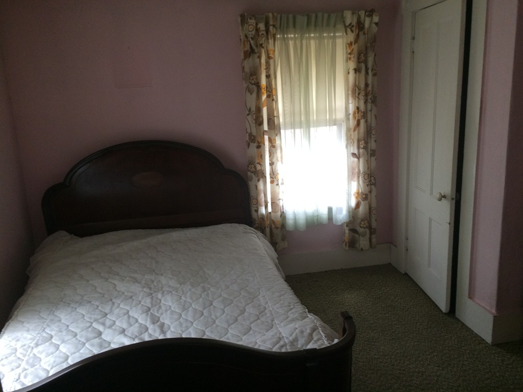 12 Frontenac Street Springfield, MA 01151 - Photo 8 of 9 a bedroom with a bed and a window