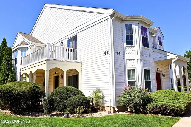 a front view of a house with yard and green space