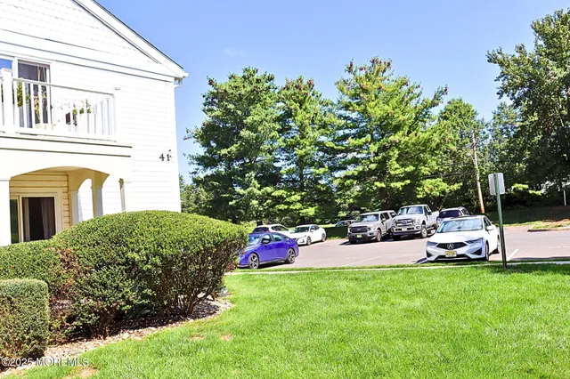 a front view of a house with swing and flower plants