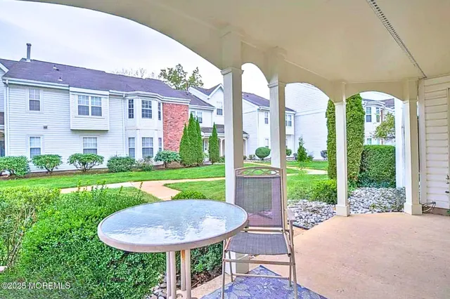 a view of a house with backyard sitting area and garden