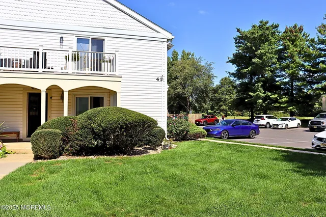 a view of a house with a backyard and porch