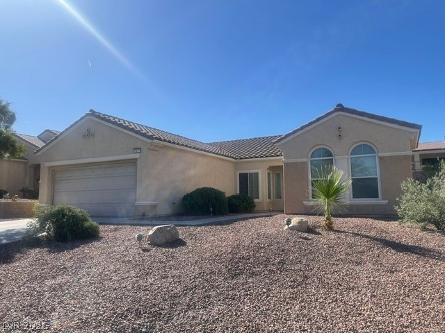 3047 Hickory Valley Road Henderson, NV 89052 - Photo 2 of 21 A well-maintained facade with graceful arched windows and an attached garage offers inviting curb appeal.