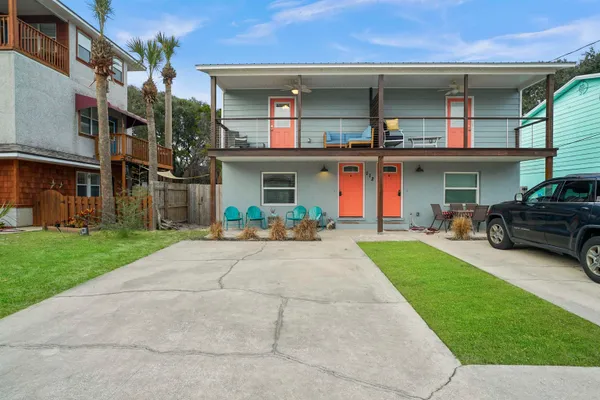 a front view of a house with a porch and a yard