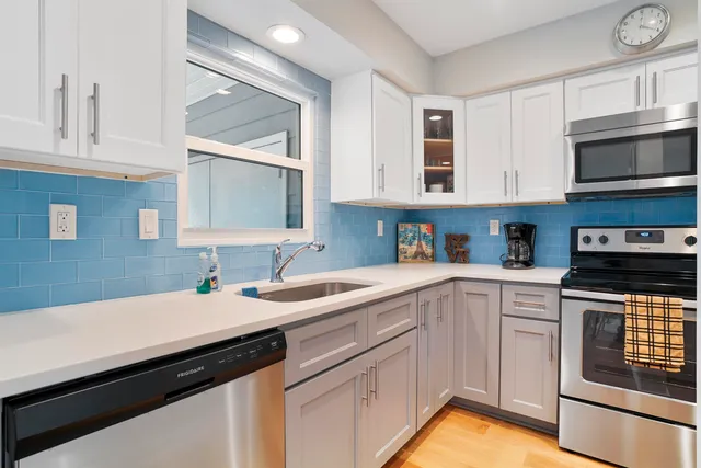 a kitchen with stainless steel appliances granite countertop a stove and a sink