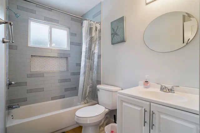 a front view of a house with garage and parking