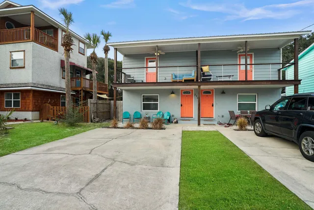 a view of a chairs and table in the back yard of the house