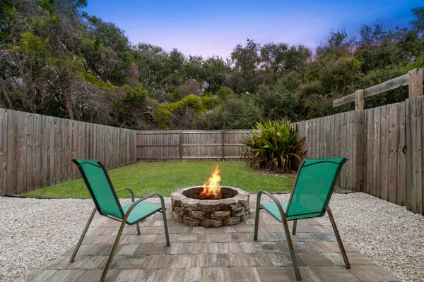 a view of a chair and table in backyard