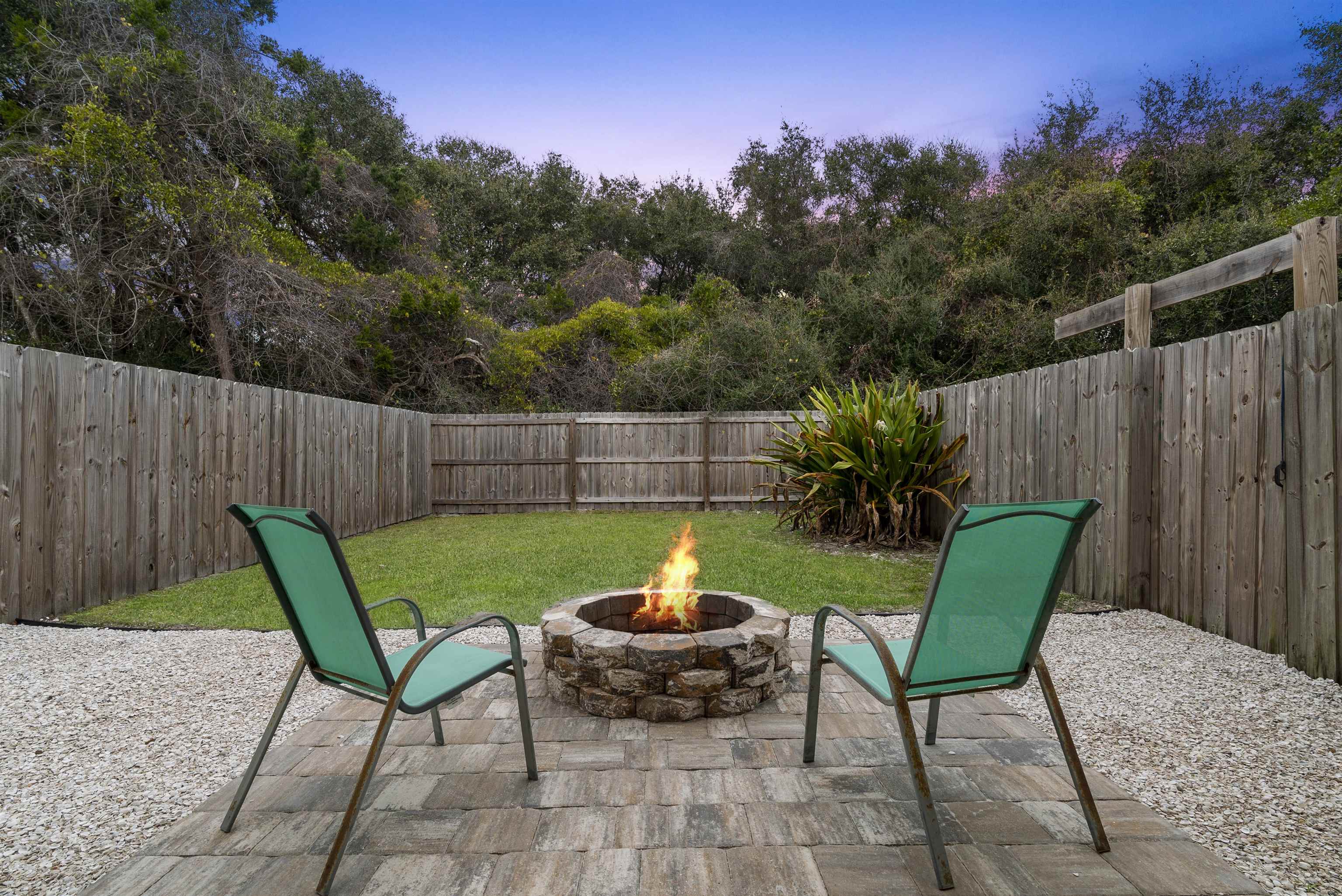 112 E Street St. Augustine, FL 32080 - Photo 21 of 41 a view of a chairs and table in the back yard of the house