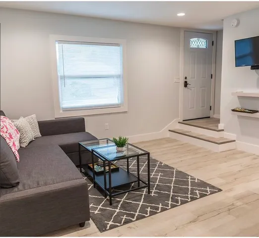 a large bed sitting in a bedroom next to a window