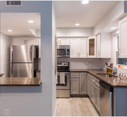 a white toilet sitting next to a bathroom sink