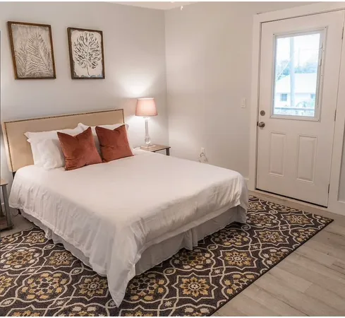 a bedroom with bed and painting on the wall