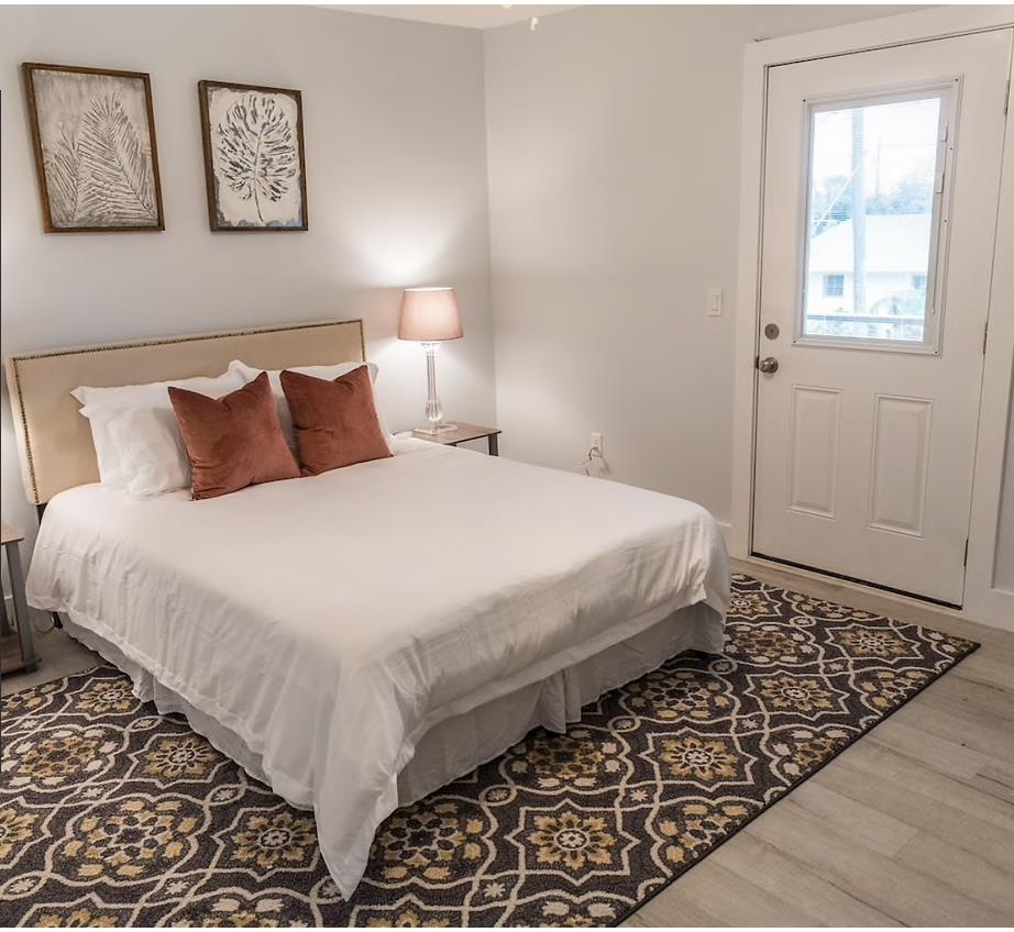 112 E Street St. Augustine, FL 32080 - Photo 30 of 41 a large bed sitting in a bedroom next to a window