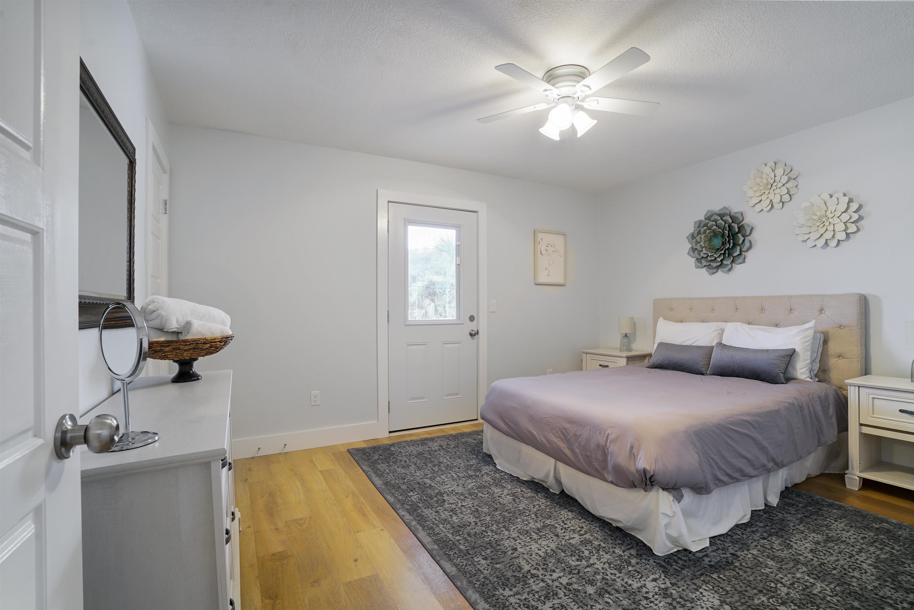 112 E Street St. Augustine, FL 32080 - Photo 4 of 41 a bedroom with a bed and a chandelier