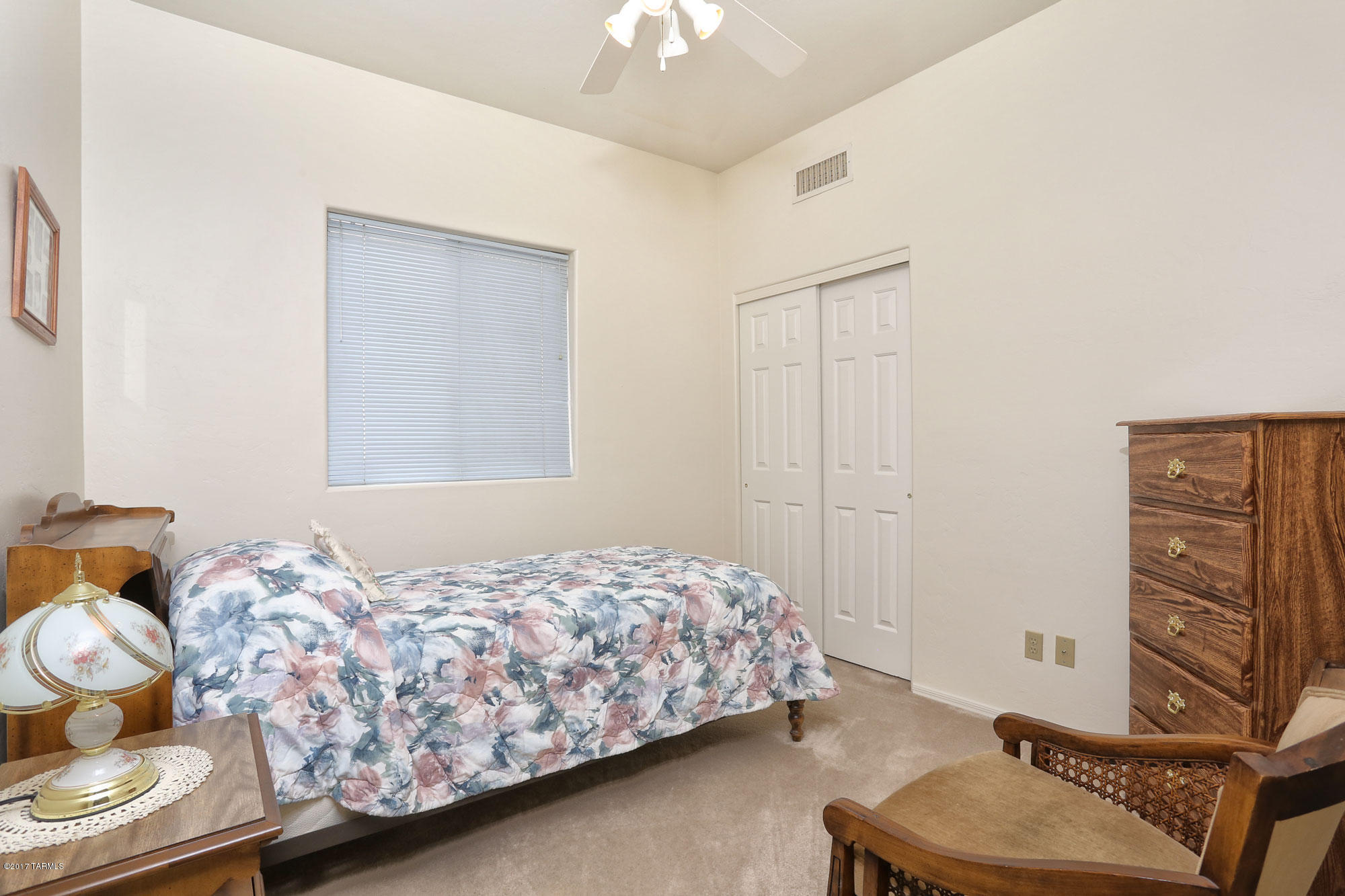 9182 East Dawn Post Road Tucson, AZ 85749 - Photo 18 of 25 a bedroom with a bed and chandelier