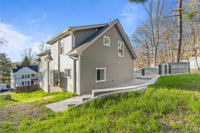 a view of backyard with wooden fence and trees