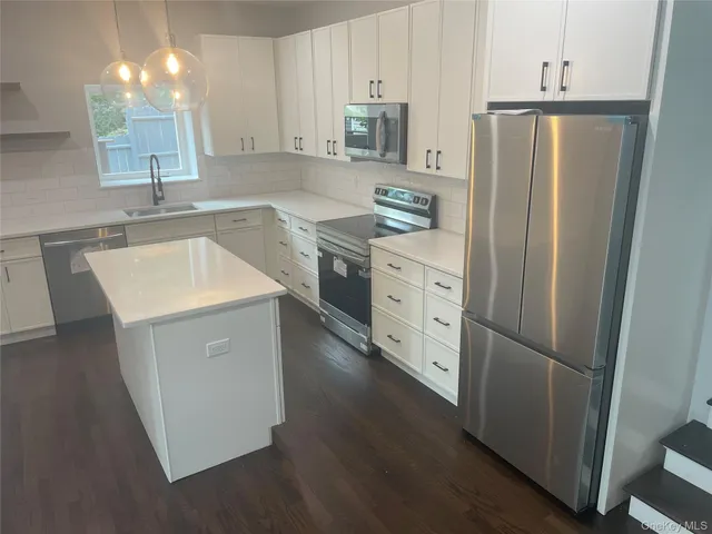 a kitchen with a sink stove and cabinets