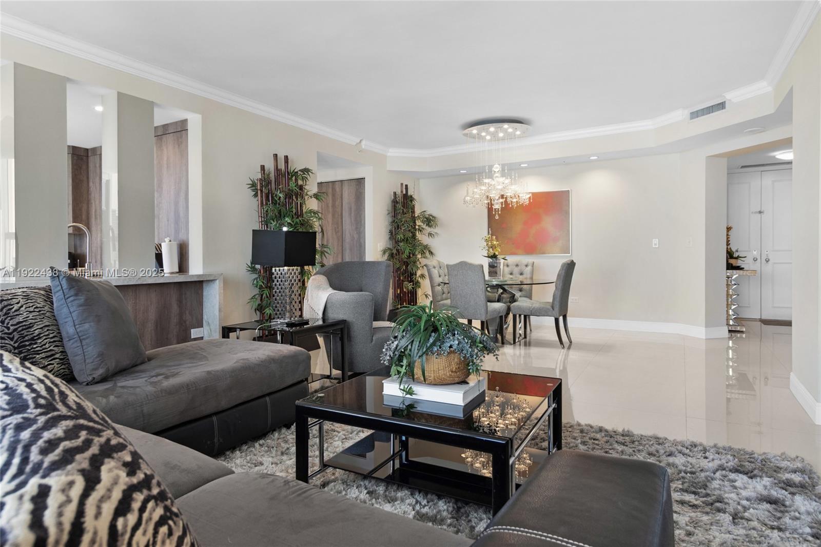 848 Brickell Key Drive, Unit 3905 Miami, FL 33131 - Photo 15 of 47 a living room with furniture and a chandelier