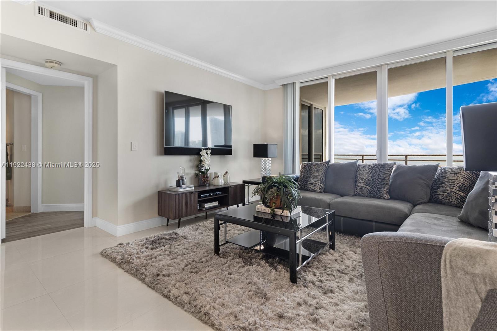 848 Brickell Key Drive, Unit 3905 Miami, FL 33131 - Photo 16 of 47 a living room with furniture and a rug