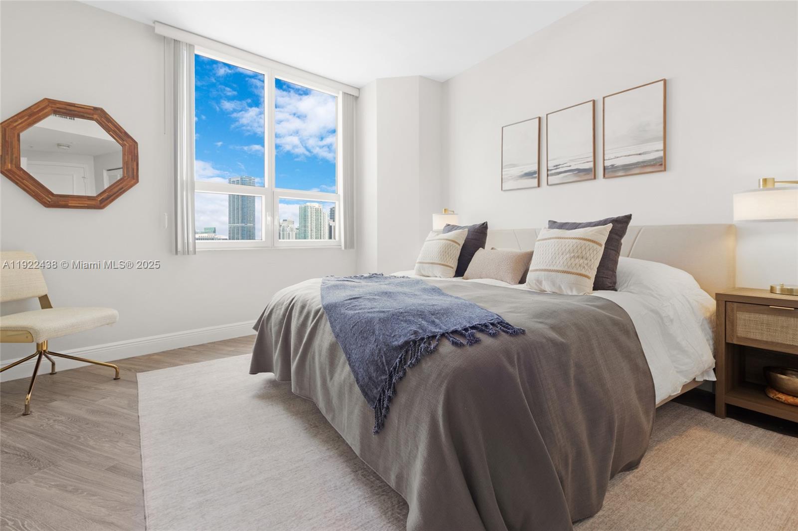 848 Brickell Key Drive, Unit 3905 Miami, FL 33131 - Photo 19 of 47 a bedroom with a bed a mirror and a window