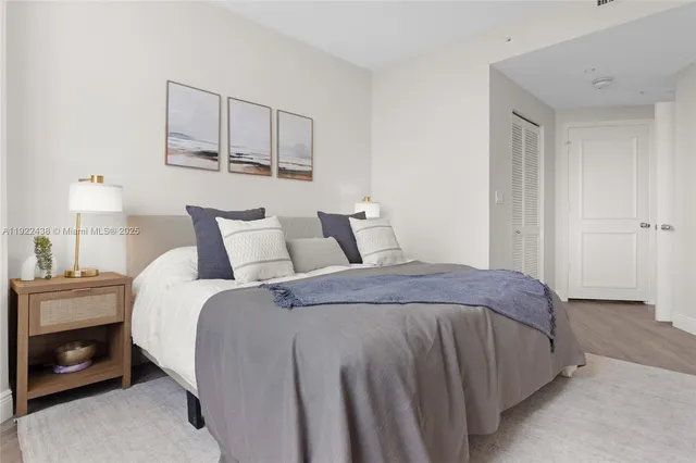 a bedroom with a bed and a night stand