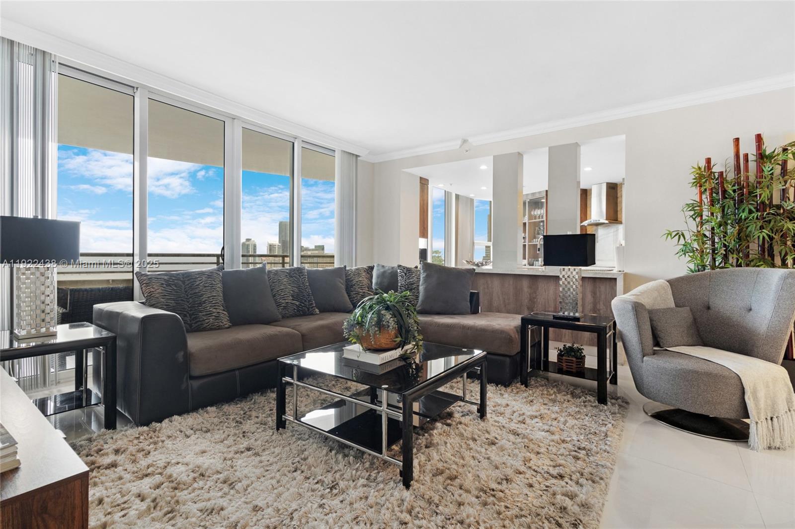 848 Brickell Key Drive, Unit 3905 Miami, FL 33131 - Photo 2 of 47 a living room with furniture and a large window