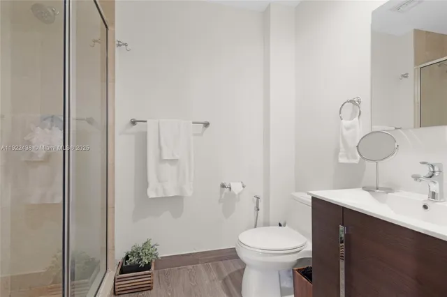 a bathroom with a sink toilet and shower