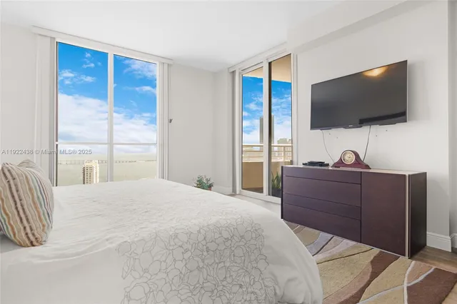 a bedroom with a bed and a flat screen tv