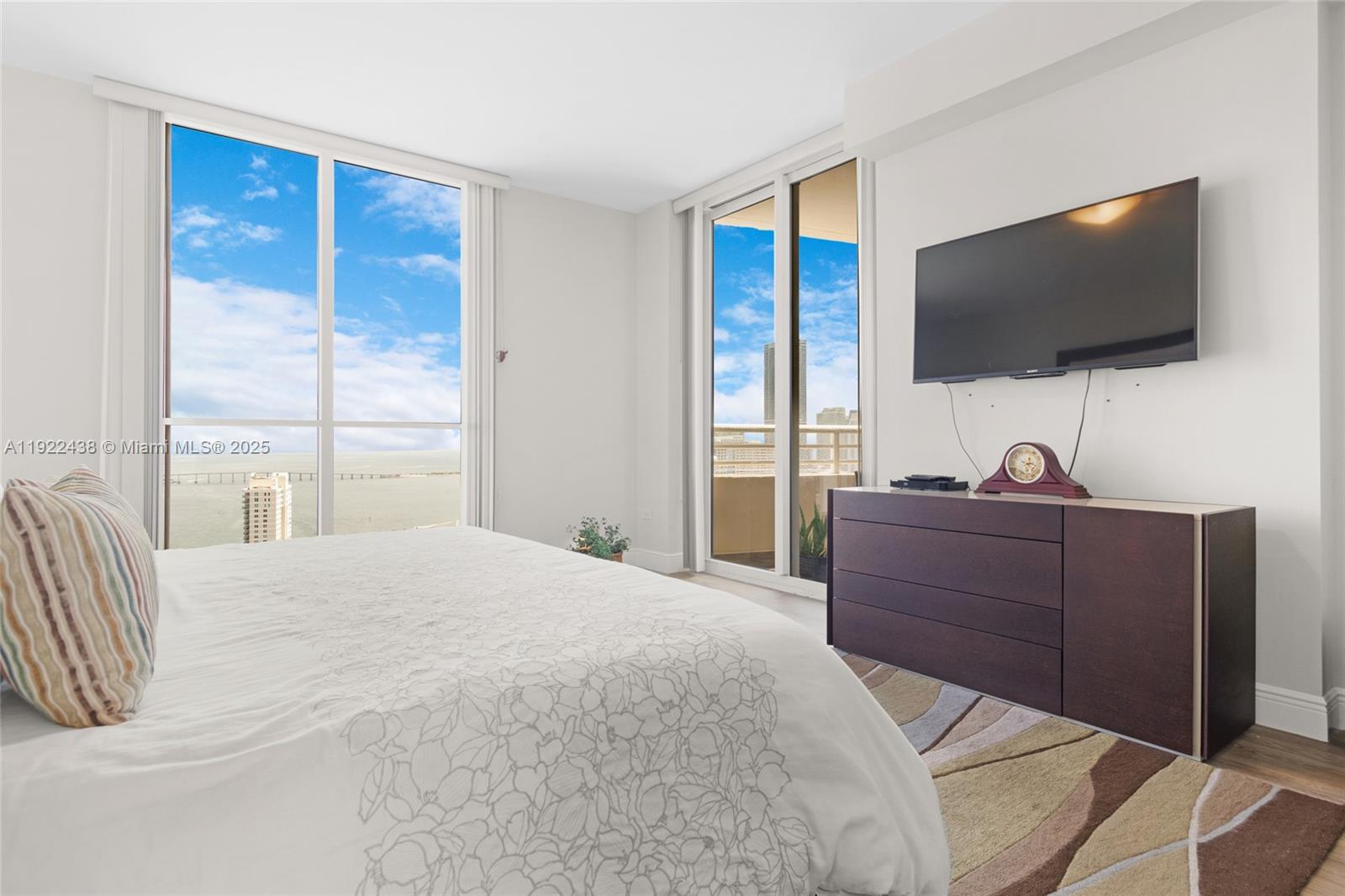 848 Brickell Key Drive, Unit 3905 Miami, FL 33131 - Photo 25 of 47 a bedroom with a bed and a flat screen tv