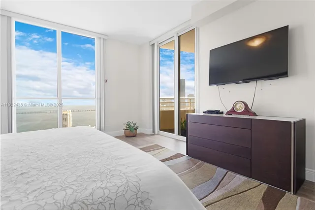 a bedroom with a bed and a flat screen tv