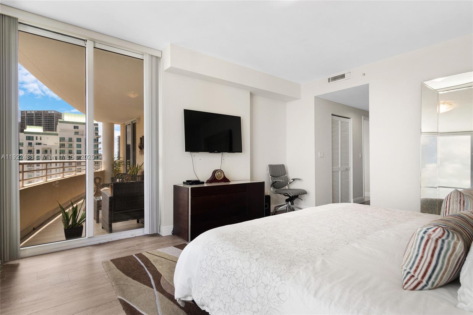 848 Brickell Key Drive, Unit 3905 Miami, FL 33131 - Photo 27 of 47 a bedroom with a bed and a flat screen tv