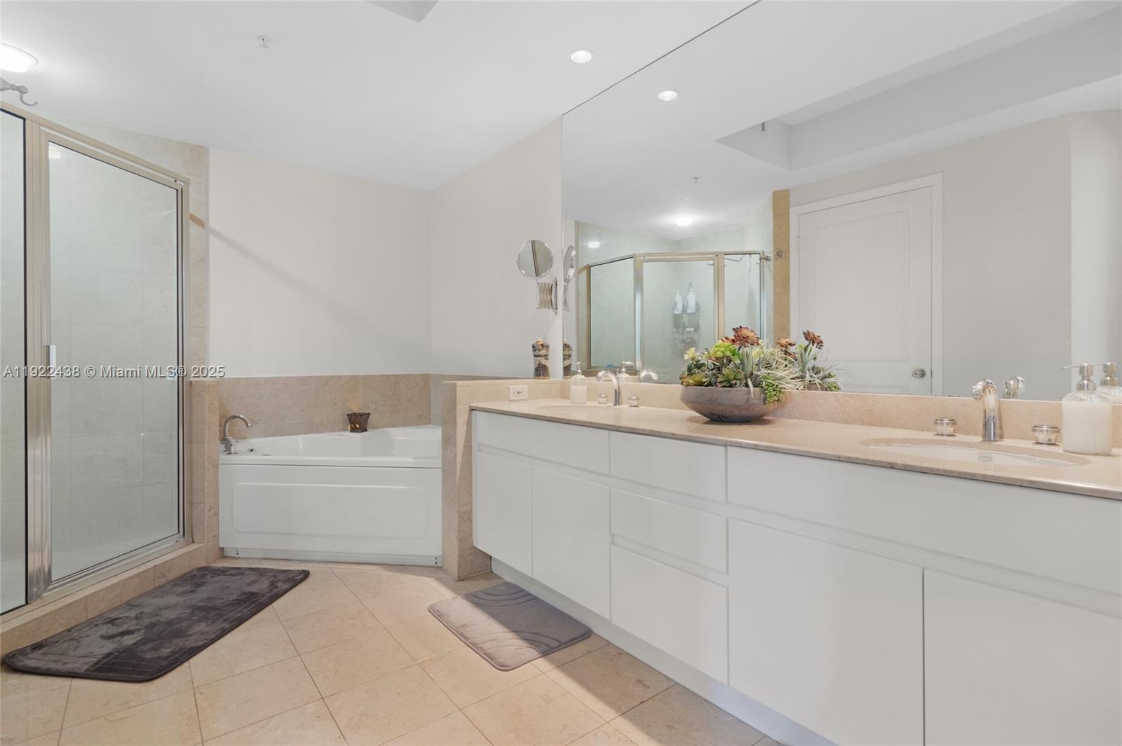 848 Brickell Key Drive, Unit 3905 Miami, FL 33131 - Photo 30 of 47 a spacious bathroom with a sink a mirror and a bathtub