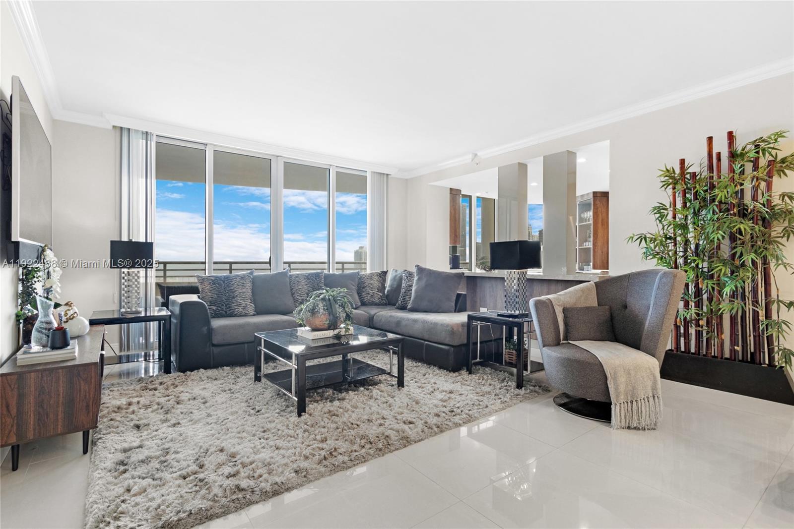 848 Brickell Key Drive, Unit 3905 Miami, FL 33131 - Photo 3 of 47 a living room with furniture and a large window