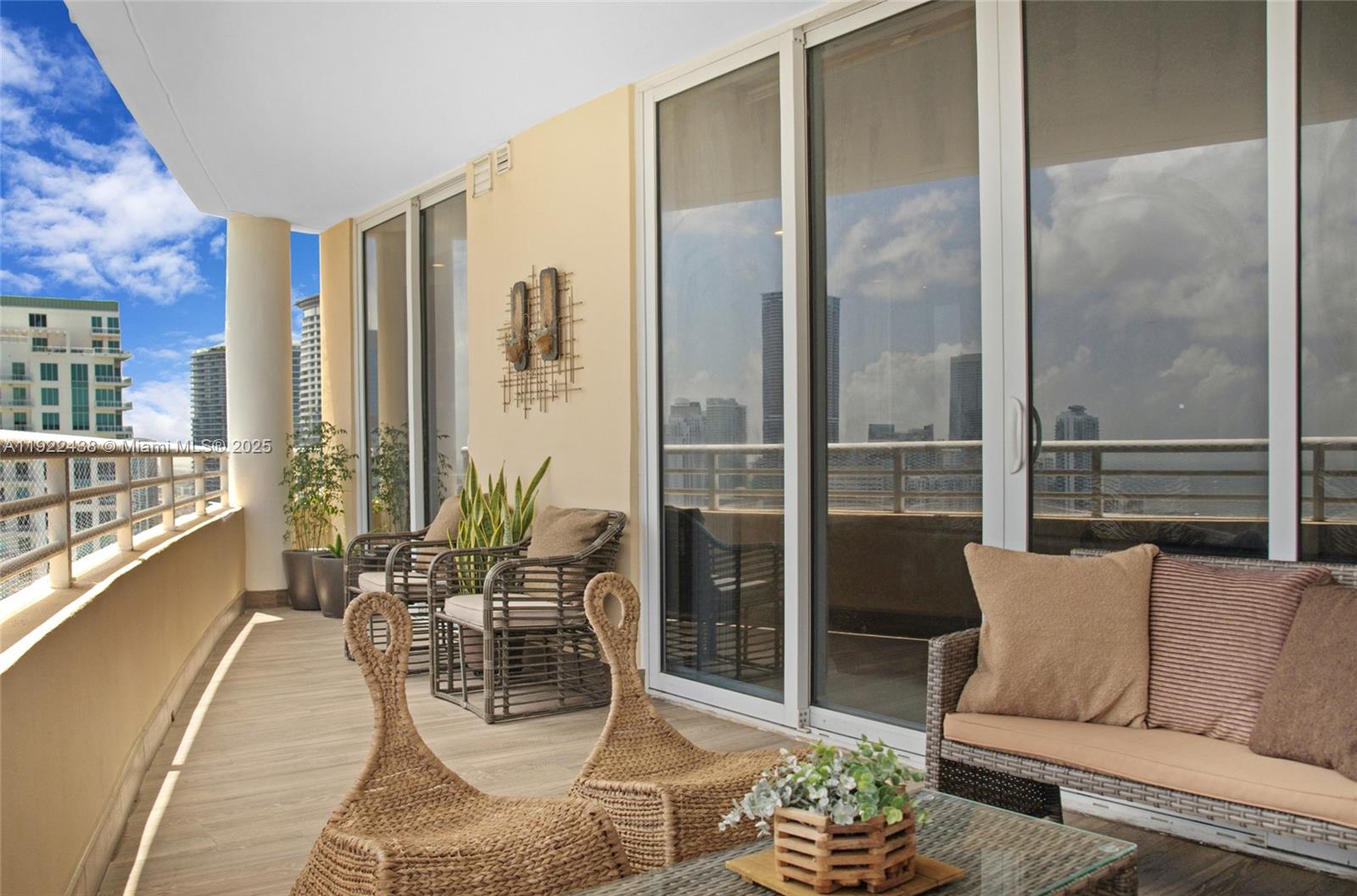 848 Brickell Key Drive, Unit 3905 Miami, FL 33131 - Photo 37 of 47 a living room with furniture and a large window