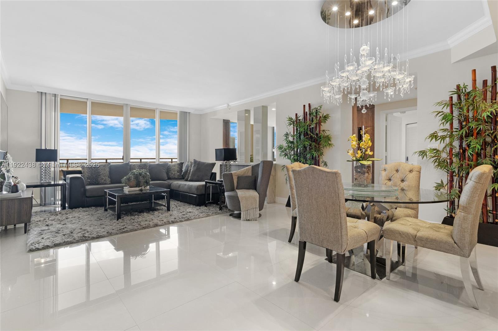 848 Brickell Key Drive, Unit 3905 Miami, FL 33131 - Photo 4 of 47 a living room with furniture and a chandelier