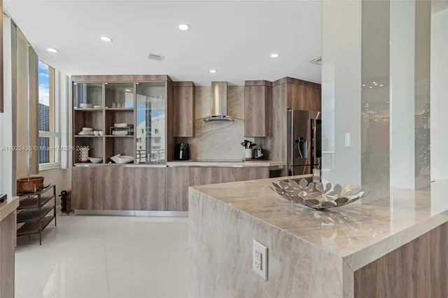 a kitchen with kitchen island granite countertop a sink and cabinets